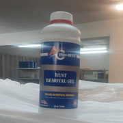 A white "AC Pro-Rust" bottle with a red cap, containing "Rust Removal Gel for Use on Vertical Surfaces," stands on a white, draped surface in an indoor setting. This powerful pro tech cleaner is ideal for thorough air conditioning maintenance on metal components by effectively removing rust and preparing surfaces for further protection.